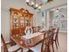 Bright dining room with wood floors, chandelier, hutch, and large windows at 4647 Stearman Dr, North Las Vegas, NV 89031