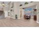 Spacious dining area with wood floors, an elegant table, and an open view to the living area at 4647 Stearman Dr, North Las Vegas, NV 89031