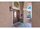 Inviting entryway with a decorative front door, textured walls, and charming exterior lighting at 4647 Stearman Dr, North Las Vegas, NV 89031