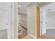 Hallway with staircase features neutral decor, storage and transitions to various rooms at 4647 Stearman Dr, North Las Vegas, NV 89031