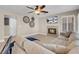 Neutral living room with fireplace, ceiling fan, recessed lights, and comfortable furnishings at 4647 Stearman Dr, North Las Vegas, NV 89031