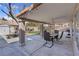 Outdoor covered patio with ceiling fan, outdoor dining table, and landscaped backyard at 4647 Stearman Dr, North Las Vegas, NV 89031