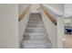 Carpeted staircase with wooden handrails leading to the upper level of the home at 4647 Stearman Dr, North Las Vegas, NV 89031