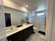 Modern bathroom with dual sinks, glass-enclosed shower, and tile flooring at 4924 Chidlaw Ave # 3, Las Vegas, NV 89115