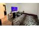 Cozy bedroom features a stylish leopard print bedding, desk, and television at 4924 Chidlaw Ave # 3, Las Vegas, NV 89115