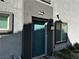 Townhome features a teal entry door and a well-lit exterior with lush landscaping at 4924 Chidlaw Ave # 3, Las Vegas, NV 89115