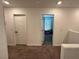 Hallway between bedrooms features carpet floors and white walls at 4924 Chidlaw Ave # 3, Las Vegas, NV 89115