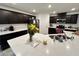 Well-lit kitchen with modern island, stainless appliances, and dark cabinetry at 4924 Chidlaw Ave # 3, Las Vegas, NV 89115