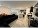 Bright open-concept living area with dark kitchen cabinets and a comfortable black sofa at 4924 Chidlaw Ave # 3, Las Vegas, NV 89115