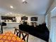 Bright living space features a modern kitchen with an island and black sofa for relaxing at 4924 Chidlaw Ave # 3, Las Vegas, NV 89115