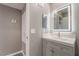 Modern bathroom with illuminated mirror, white vanity top, and gray cabinet at 5000 Red Rock St # 120, Las Vegas, NV 89118