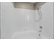 Close-up of pristine white bathtub with shower fixtures and tile surround at 5000 Red Rock St # 120, Las Vegas, NV 89118