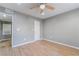 Bedroom with wood-look flooring, neutral walls, and ceiling fan at 5000 Red Rock St # 120, Las Vegas, NV 89118