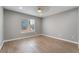 Bright bedroom with a ceiling fan, wood-style flooring, and large window at 5000 Red Rock St # 120, Las Vegas, NV 89118