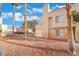 Attractive condo building exterior, boasting mature palm trees and clean landscaping, providing comfortable living at 5000 Red Rock St # 120, Las Vegas, NV 89118