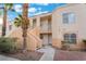 Condominium building with tan stucco, covered walkways, and tropical landscaping at 5000 Red Rock St # 120, Las Vegas, NV 89118