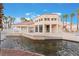Charming community clubhouse with pool and pond views, lined with palm trees and offering recreational space at 5000 Red Rock St # 120, Las Vegas, NV 89118