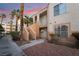 Inviting two-story condo featuring charming architecture and well-maintained landscaping, set against a colorful sunset at 5000 Red Rock St # 120, Las Vegas, NV 89118