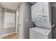 Efficient laundry area with stacked washer and dryer, plus neutral walls and wood-look floors at 5000 Red Rock St # 120, Las Vegas, NV 89118