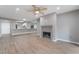 Cozy living room with hardwood floors, fireplace, and mirror feature wall reflecting into the kitchen at 5000 Red Rock St # 120, Las Vegas, NV 89118