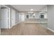 Bright, open living area with hardwood floors and a large mirror feature wall, open to the kitchen at 5000 Red Rock St # 120, Las Vegas, NV 89118