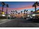 Exterior shot of parking lot with covered parking and palm trees at sunset at 5000 Red Rock St # 120, Las Vegas, NV 89118