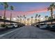 Exterior shot of condo buildings with covered parking and palm trees at sunset at 5000 Red Rock St # 120, Las Vegas, NV 89118