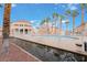 Inviting community pool with palm trees and clubhouse, offering a relaxing and resort-like ambiance for residents at 5000 Red Rock St # 120, Las Vegas, NV 89118