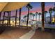 Beautiful outdoor pool area surrounded by palm trees, offering a serene and tropical atmosphere at sunset at 5000 Red Rock St # 120, Las Vegas, NV 89118