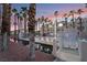 Beautiful outdoor pool area surrounded by palm trees, offering a serene and tropical atmosphere at sunset at 5000 Red Rock St # 120, Las Vegas, NV 89118