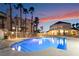 Outdoor pool area with lounge chairs, palm trees and beautiful sunset at 5000 Red Rock St # 120, Las Vegas, NV 89118