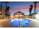 Outdoor pool area with lounge chairs, palm trees and beautiful sunset at 5000 Red Rock St # 120, Las Vegas, NV 89118