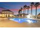Outdoor pool area with lounge chairs, palm trees and beautiful sunset at 5000 Red Rock St # 120, Las Vegas, NV 89118