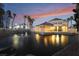 Exterior view of complex with water feature, fountain, and palm trees at dusk at 5000 Red Rock St # 120, Las Vegas, NV 89118