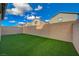 Enjoy this low maintenance backyard featuring green artificial turf and a tall privacy wall at 5040 Serene Skies St, Las Vegas, NV 89130
