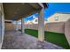 Backyard with artificial turf, covered patio and brick pavers at 5040 Serene Skies St, Las Vegas, NV 89130