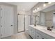 Bathroom featuring dual sink vanity, framed shower, and wood look tile floors at 5040 Serene Skies St, Las Vegas, NV 89130