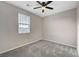 Cozy bedroom featuring carpet, ceiling fan and window at 5040 Serene Skies St, Las Vegas, NV 89130