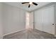 Bedroom showcasing neutral walls, carpet floors, white closet doors, and ceiling fan at 5040 Serene Skies St, Las Vegas, NV 89130