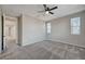 Bedroom showcasing neutral walls, carpet floors, two windows, and ceiling fan at 5040 Serene Skies St, Las Vegas, NV 89130