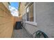 Exterior shot of the home featuring an air conditioning unit, hose, and window at 5040 Serene Skies St, Las Vegas, NV 89130