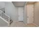 Welcoming foyer features a staircase, closet, and wood-look tile flooring at 5040 Serene Skies St, Las Vegas, NV 89130