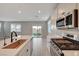 Modern kitchen island with gas range, stainless appliances, and a backyard view at 5040 Serene Skies St, Las Vegas, NV 89130