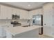 Bright kitchen with an island featuring stainless steel appliances and white cabinetry at 5040 Serene Skies St, Las Vegas, NV 89130