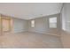 Bright living room featuring wood-look tile floors and large windows with natural light at 5040 Serene Skies St, Las Vegas, NV 89130