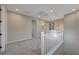 Open loft area with neutral carpet, chandelier, and ample lighting at 5040 Serene Skies St, Las Vegas, NV 89130