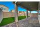 Spacious covered patio with stone flooring and artificial grass in backyard at 5040 Serene Skies St, Las Vegas, NV 89130
