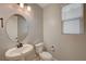 Neutral powder room features pedestal sink, updated fixtures, and a window at 5040 Serene Skies St, Las Vegas, NV 89130