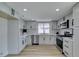 Bright kitchen with stainless steel appliances, white cabinets, and wood-look floors at 5508 Kettering Pl, Las Vegas, NV 89107