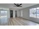 Spacious living room with modern ceiling fan, wood flooring, and bright natural light at 5508 Kettering Pl, Las Vegas, NV 89107